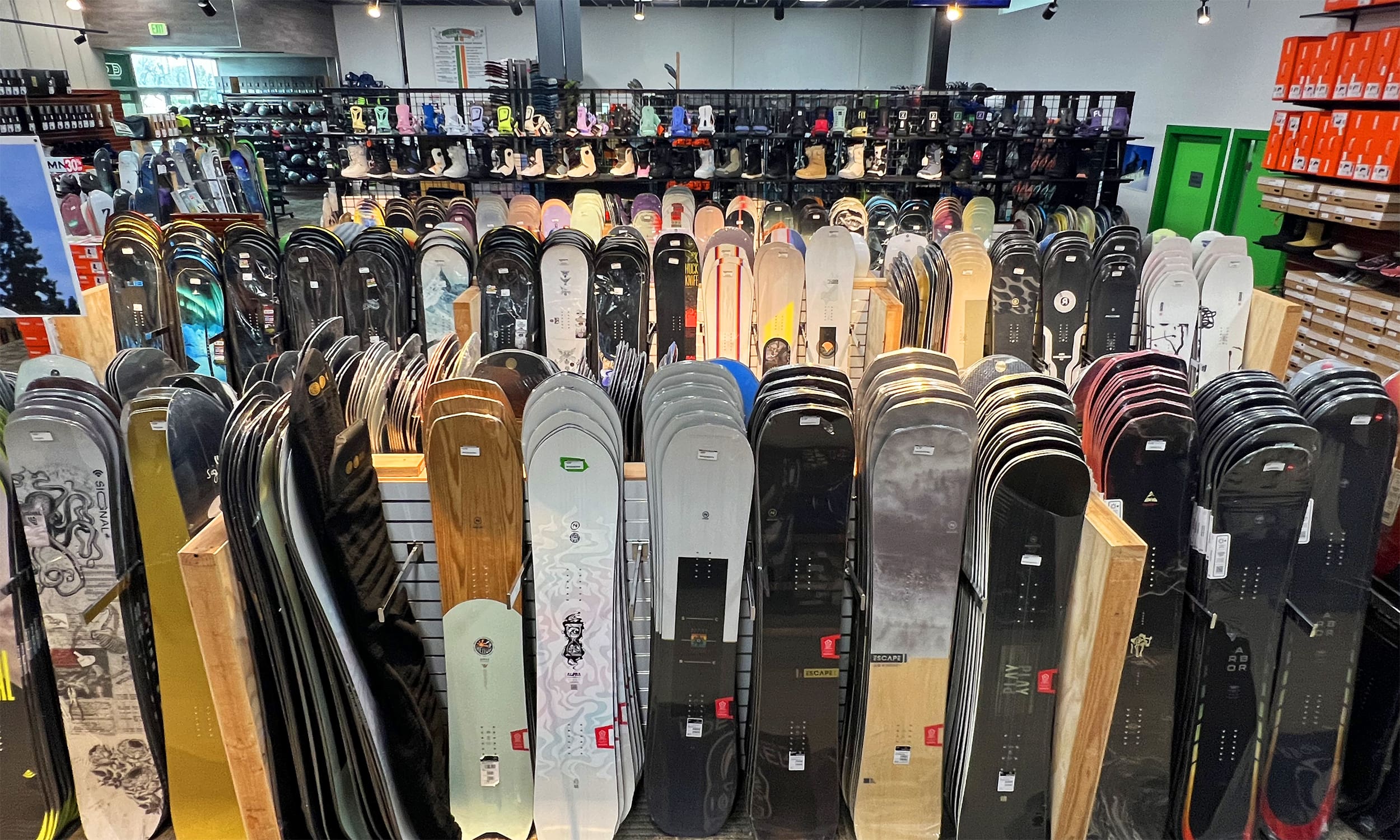 A room filled with lots of skateboards and racks.