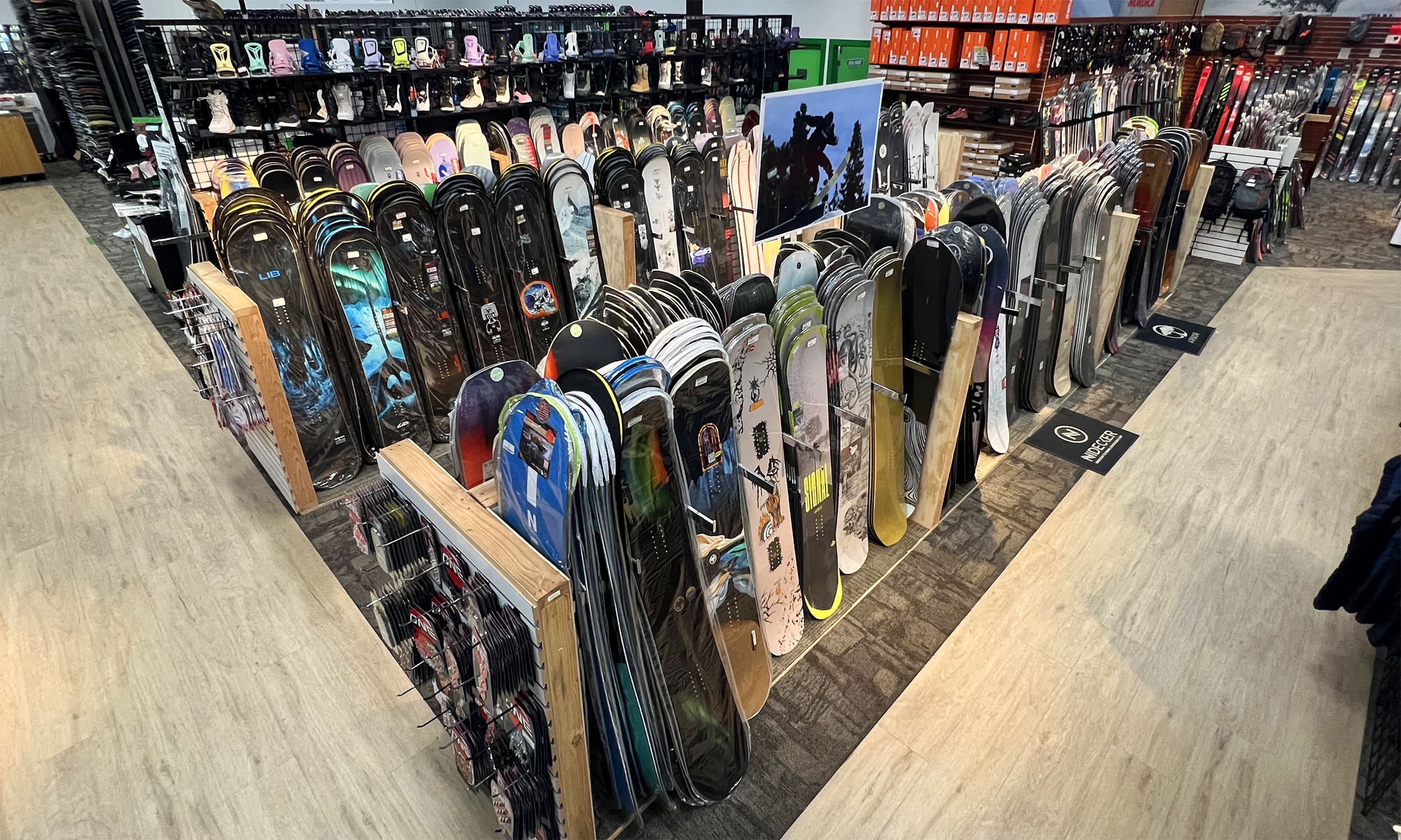 A room filled with lots of different types of snowboards.