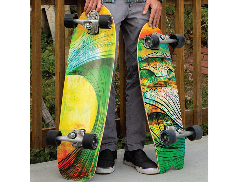 A person holding two skateboards in their hands.