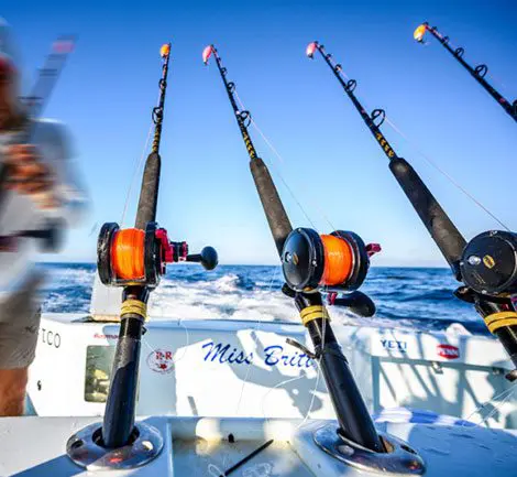 A group of fishing rods on the side of a boat.