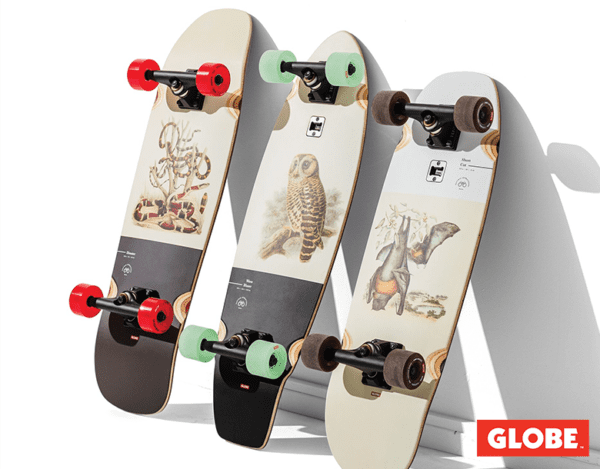 A group of three skateboards with different designs on them.